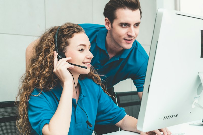 Professional phone receptionist with headset assisting customer inquiries